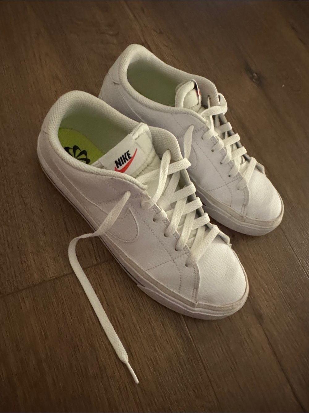 Nike Women’s White Low-Top Sneakers with Subtle Orange Logo